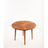 A 20th Century starburst coffee table, the circular top of six segments over round tapering legs,