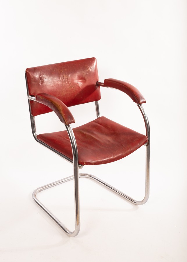 A Pel chrome framed desk chair, the bent frame with upholstered back,