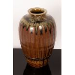 Mike Dodd (born 1943), a stoneware vase, with flared rim and running ash glaze over fluted sides,