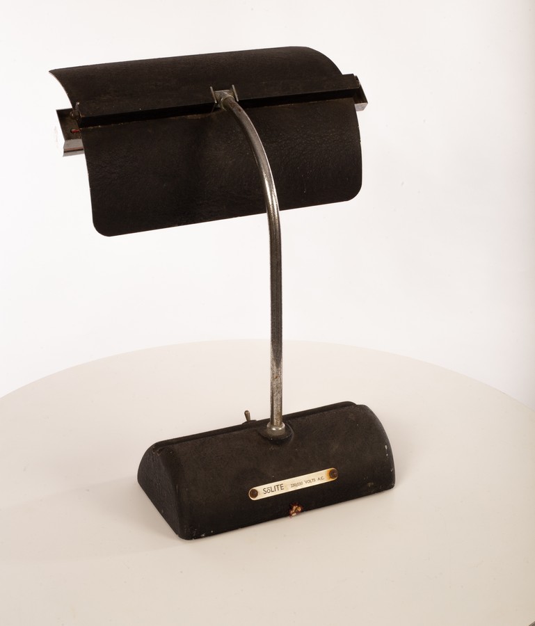 A metal desk lamp, the textured aluminium articulated shade on chrome painted arm,