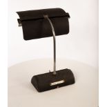 A metal desk lamp, the textured aluminium articulated shade on chrome painted arm,