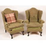 A pair of wingback armchairs on dwarf cabriole legs with green upholstery,