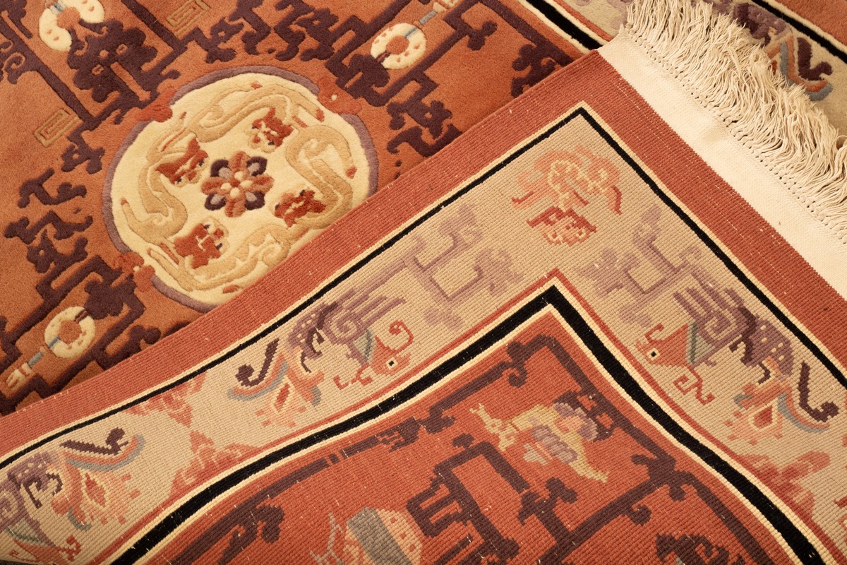 A Chinese superwash rug, the peach field with vases and centred by an ivory medallion of dragons, - Image 4 of 4