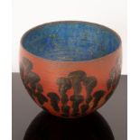 Geoffrey Eastop (British 1921-2014), a red ground bowl with bronzed decoration,