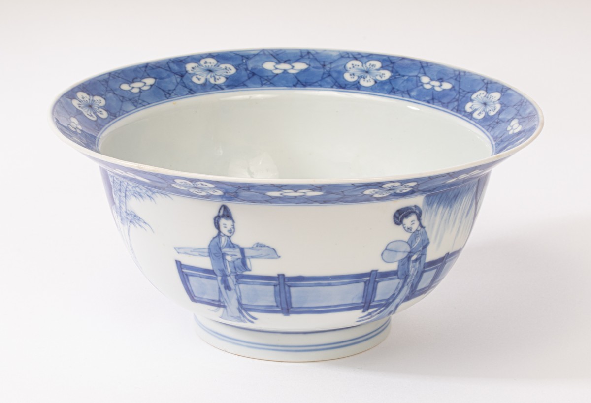 A Chinese blue and white porcelain bowl, Kangxi, depicting ladies and a boy playing in the garden,