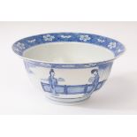 A Chinese blue and white porcelain bowl, Kangxi, depicting ladies and a boy playing in the garden,