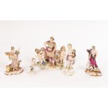 A Meissen figure of a cherub with a lyre and four Meissen style figures,