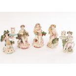 Three Derby figures of seated cherubs emblematic of the seasons and two candlestick figures,