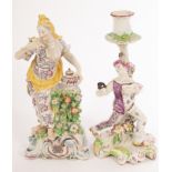 A Bow figure of a Classical maiden beside an urn,