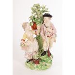 A Derby figure group emblematic of Autumn and Summer, a huntsman and lady with flowers,
