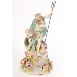 A Derby figure of Neptune standing on a shell, with a dolphin and shells on a rocky base,