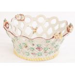 A Derby basket with pierced lattice sides topped with circles of painted flowers,