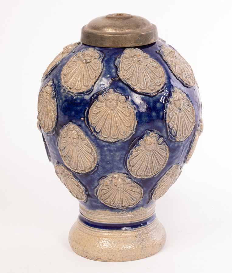 A Westerwald stoneware jug, late 17th Century, with multiple panels of angel heads on a blue ground, - Image 8 of 11