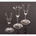 Three 18th Century wine glasses, two having bucket bowls and shoulder knops, two with folded feet,