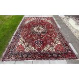 A Heriz carpet, North West Persia, the rust red abrashed field with small birds throughout,