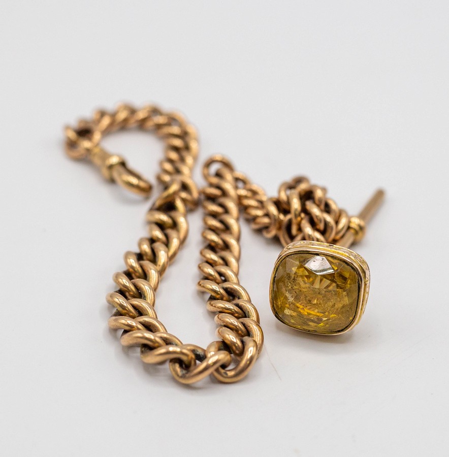 A 9ct gold Albert chain with T-bar and 9ct gold fob pendant set a citrine,
