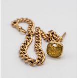 A 9ct gold Albert chain with T-bar and 9ct gold fob pendant set a citrine,
