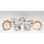 A pair of Coalport plates painted with flower sprigs within a border of red and purple scrolls,