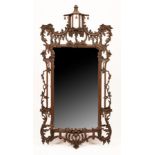 A Chinese Chippendale style wall mirror, the carved frame with a pagoda top,