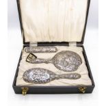 A cased set of silver dressing brushes and mirror, W I Broadway & Co, Birmingham 1972,