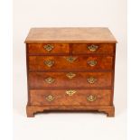 An 18th Century walnut and featherbanded chest of two short over three long drawers on later