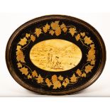 An oval toleware tray with a central pastoral scene and border of grapes and vines,