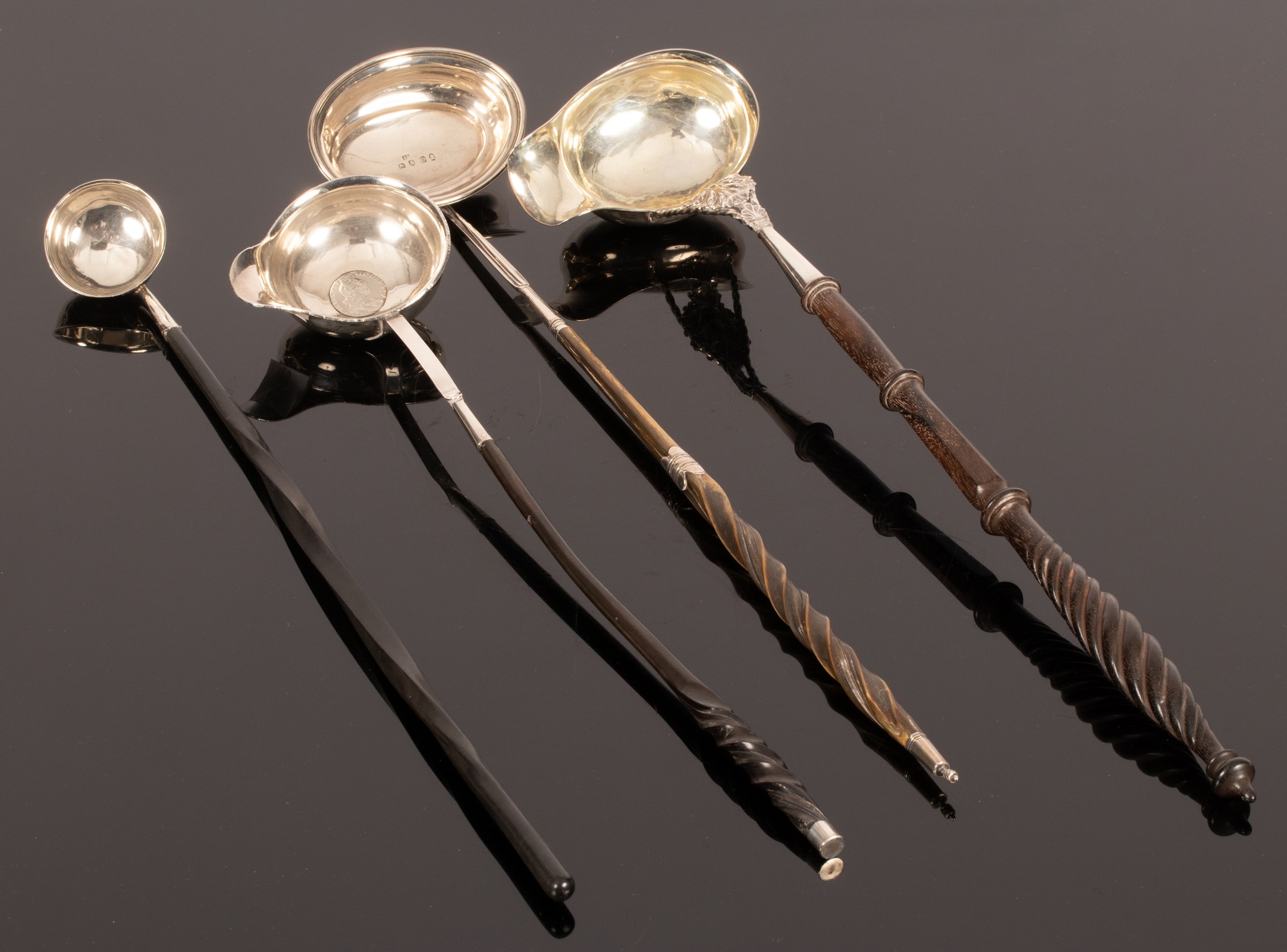 Four silver toddy ladles of various sizes and designs, Georgian and later,