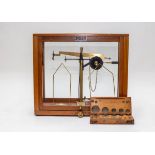 A set of scales by Griffin & George Ltd., in a glass case, 41.5cm x 36.