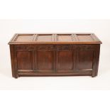 A Charles II oak four panel coffer, with a hinged lid and lunette carved frieze, 143cm wide,