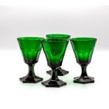 Four early 20th Century green glass wine glasses on hexagonal bases, 12.