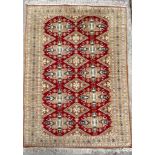 A Bokhara rug, West Turkestan, the madder field with lozenge and cruciform guls,