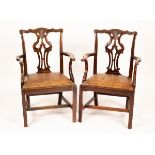 A pair of Chippendale style mahogany armchairs with shaped and carved cresting rails,