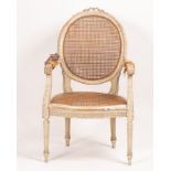 A cane seated open armchair with oval back and acanthus clad arms on turned and fluted legs