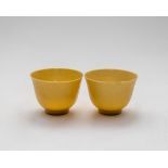 A pair of Chinese yellow glazed tea cups, 20th Century, the base marked 'Daqing Guangxu Nianzhi', 6.