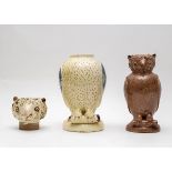 Two earthenware vessels in the form of owls, one in a cream slip heightened in blue,