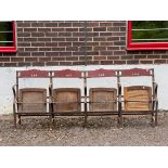 A row of four 20th Century theatre seats, iron frame with painted wooden seats and back rests,