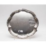 An Edwardian silver salver, Martin, Hall & Co, Sheffield 1905, lobed form on three scroll feet,