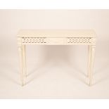 A white painted side table with a pierced frieze,