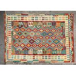 An Afghan Kilim, the polychrome field of rows of serrated motifs,