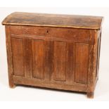 An 18th Century oak coffer, with domed cover and panelled front, 122cm wide, 64cm deep,