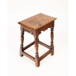 A Charles II jointed oak stool, the rectangular top with scroll carved frieze,