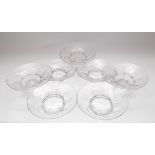 A set of three high and four low clear glass comports with a swirl design,
