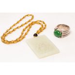 A Chinese jadeite and silver ring and a jade carved plaque, 20th Century,