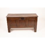 A 17th Century oak coffer with triple panel front,