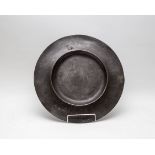 A pewter broad rimmed charger, circa 1660,