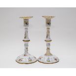 A pair of enamel candlesticks, probably Bilston, with floral decoration on a white ground, 25.