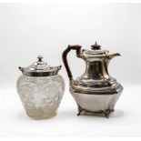 An Edwardian cut glass biscuit barrel with silver mounts, Sheffield 1905 and a silver hot water jug,