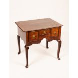A George II oak lowboy, the top with re-entrant corners and drawers with cross banding,