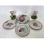 Four pink flower painted faience plates,