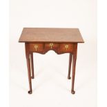 A George II oak lowboy, the three drawers above a shaped apron on turned legs with pad feet,